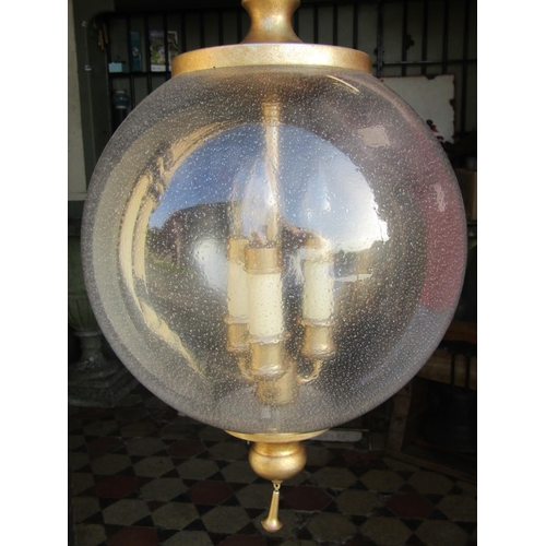 2106 - A contemporary hanging globular shaped glass and light gilt metal ceiling light with three interior ... 