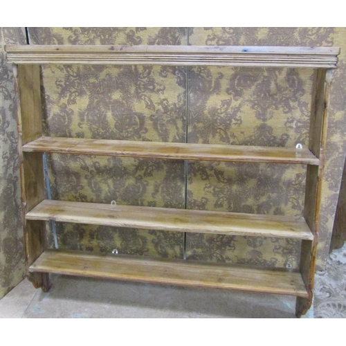 2174 - A stripped pine country made wall rack with three fixed shelves flanked by chamfered and moulded det... 