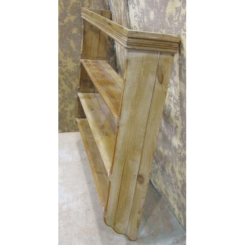 2174 - A stripped pine country made wall rack with three fixed shelves flanked by chamfered and moulded det... 