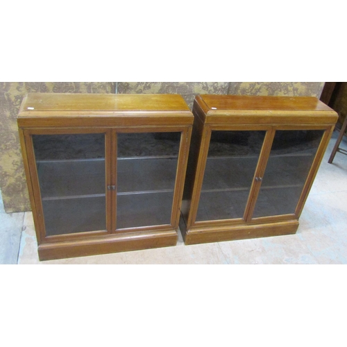 2182 - A pair of early 20th century walnut floorstanding dwarf side cabinets/bookcases with inlaid crossban... 