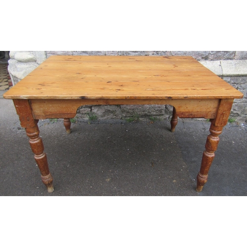 2186 - A late Victorian stripped pine kitchen table with rectangular boarded top over a chamfered frieze an... 