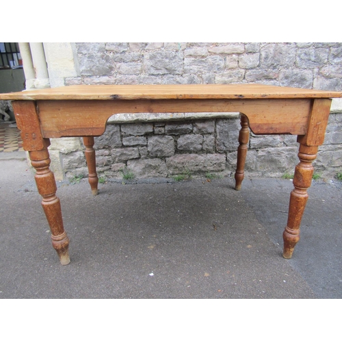 2186 - A late Victorian stripped pine kitchen table with rectangular boarded top over a chamfered frieze an... 