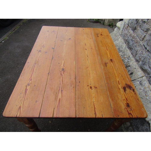 2186 - A late Victorian stripped pine kitchen table with rectangular boarded top over a chamfered frieze an... 