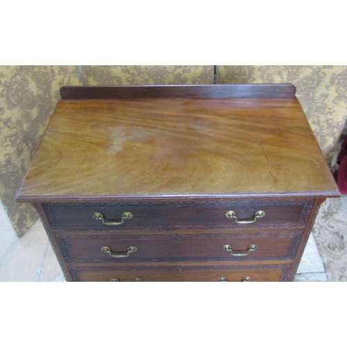 2194 - An Edwardian mahogany Chippendale revival bedroom chest of three long drawers with blind fret detail... 