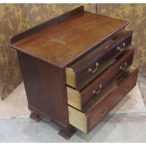 2194 - An Edwardian mahogany Chippendale revival bedroom chest of three long drawers with blind fret detail... 