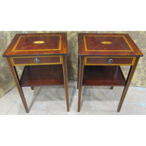 2195 - A pair of reproduction two tier lamp tables with inlaid detail,  each enclosed by a frieze drawer ra... 