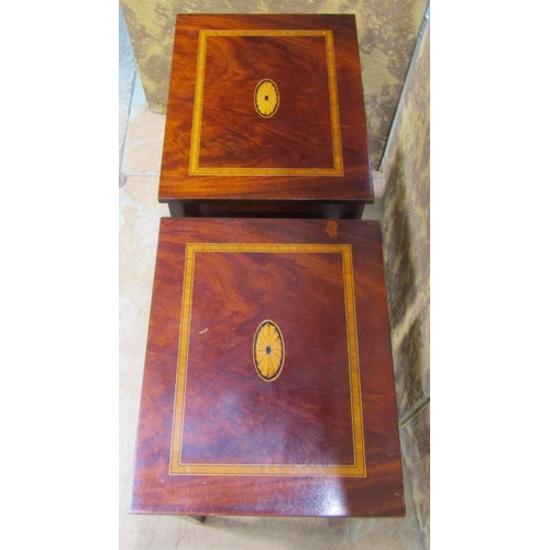 2195 - A pair of reproduction two tier lamp tables with inlaid detail,  each enclosed by a frieze drawer ra... 