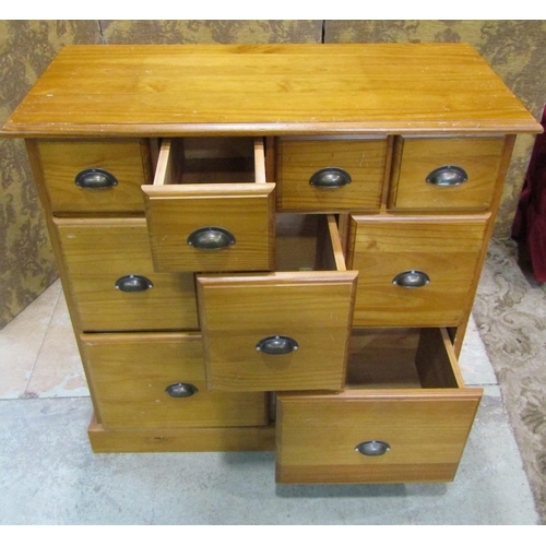 2196 - A contemporary pine chest fitted with an arrangement of nine drawers with cup handles 88 cm high