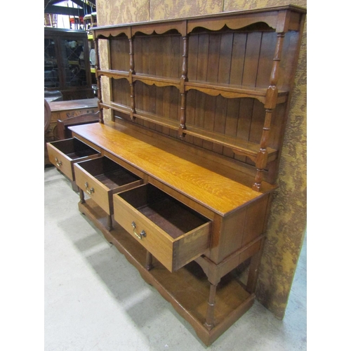 2197 - A Georgian style medium oak pot board kitchen dresser with three frieze drawers and shaped apron ben... 