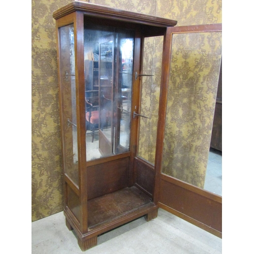 2199 - An early 20th century freestanding display cabinet with mirror panelled back enclosed by a full leng... 