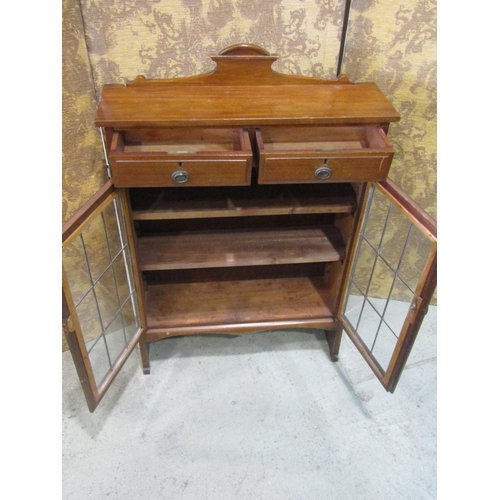 2211 - An Edwardian mahogany side cupboard with leaded light doors and two frieze drawers