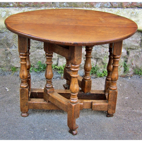 2215 - A small old English style oak gateleg occasional table, 60 cm max