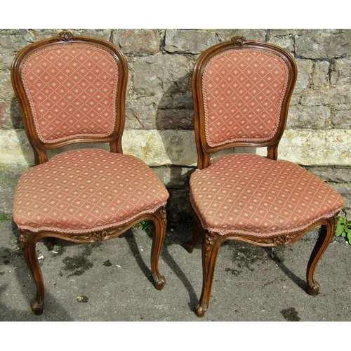 2267 - A pair of French side chairs with carved and moulded framework upholstered seats and backs