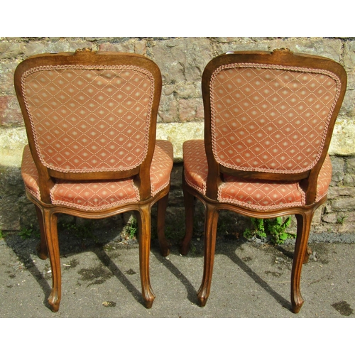 2267 - A pair of French side chairs with carved and moulded framework upholstered seats and backs