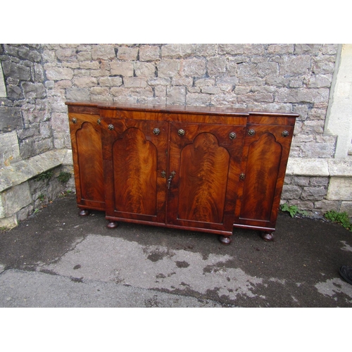 2270 - A Regency mahogany breakfront side cupboard enclosed by four arched panelled doors with applied flor... 