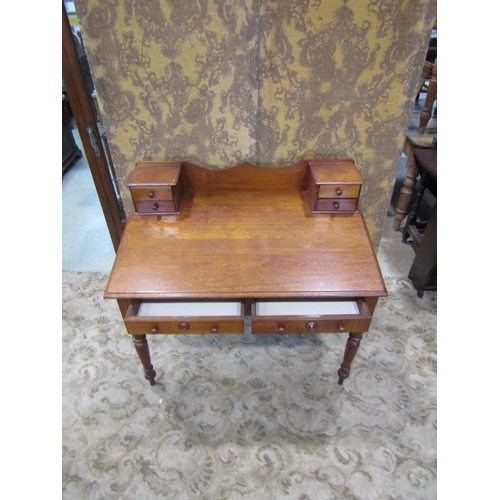 2274 - A 19th century satin birch writing desk with sloping top over two frieze drawers on turned supports ... 