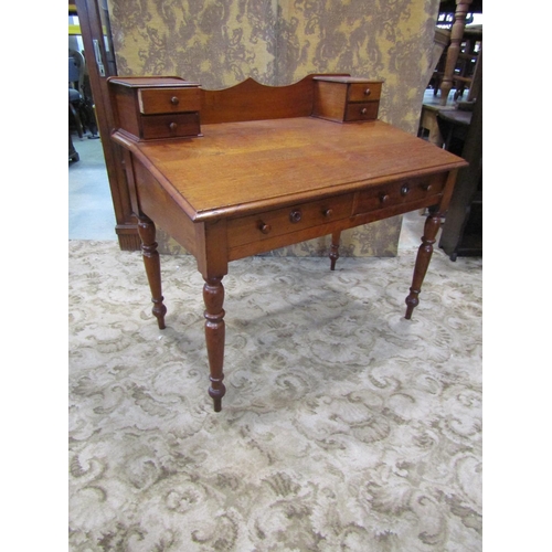 2274 - A 19th century satin birch writing desk with sloping top over two frieze drawers on turned supports ... 