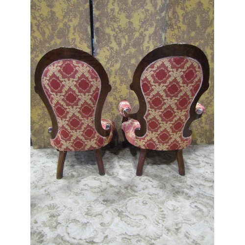 2307 - A pair of Victorian style drawing room chairs of graduated form with carved cabriole forelegs