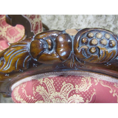 2307 - A pair of Victorian style drawing room chairs of graduated form with carved cabriole forelegs