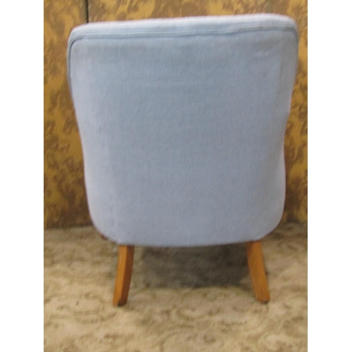 2315 - An Edwardian style tub chair with deep seat, buttoned back and upholstered finish on shaped forelegs