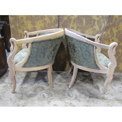 2319 - A pair of bleached beechwood tub chairs in an Empire manner with swan neck detail on shaped supports... 