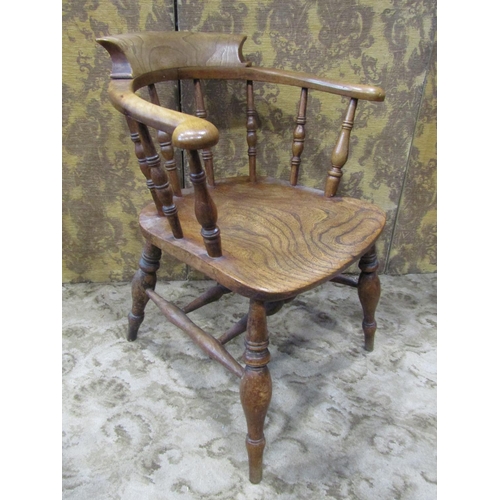 2320 - A 19th century elm captain's chair of usual form with turned spindles