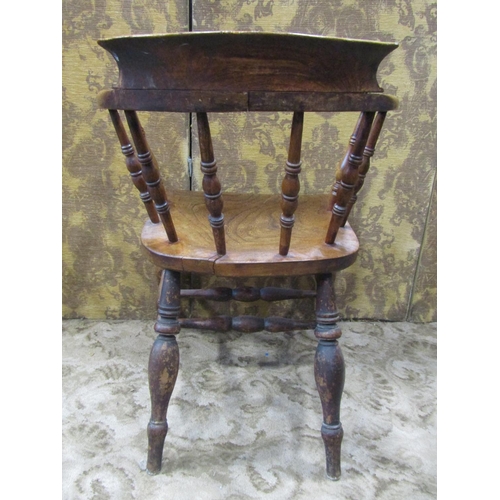 2320 - A 19th century elm captain's chair of usual form with turned spindles