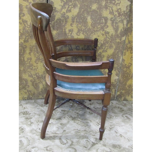 2322 - A late 19th century mahogany office chair with stick back and upholstered seat on turned supports