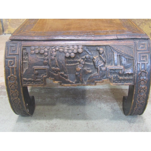 2323 - A Chinese hardwood opium table with carved detail, 110 cm long