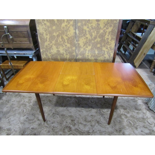 2349 - A Meredew teak extending dining table raised on four turned and tapering supports, together with a s... 