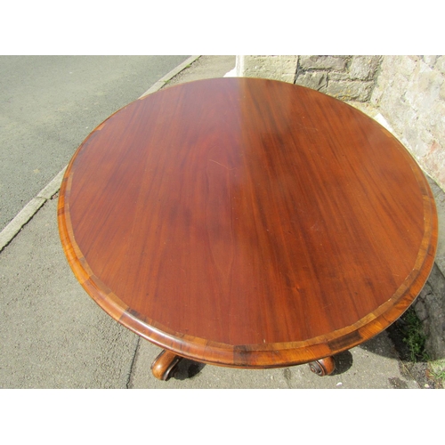 2394 - A Victorian mahogany loo table the oval top raised on a carved pillar and shaped supports, 140cm max