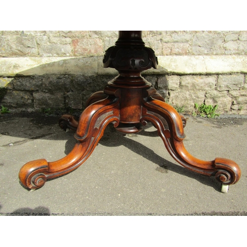 2394 - A Victorian mahogany loo table the oval top raised on a carved pillar and shaped supports, 140cm max