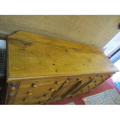 2431 - A Victorian pine kitchen dresser, central arched and panelled doors flanked by an arrangement of nin... 