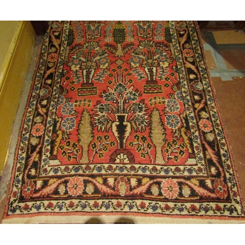 2725 - A very long eastern style runner, with repeating floral and vase detail, upon a pink ground within n... 