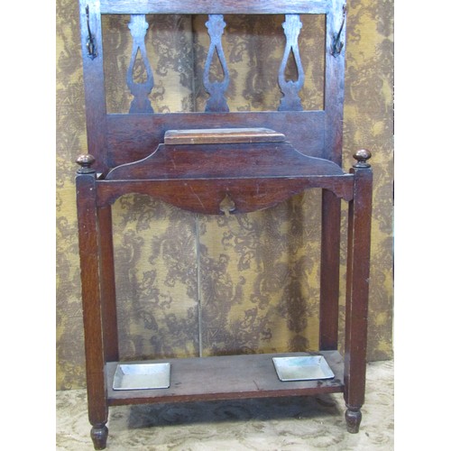 2351A - An early 20th century Arts & Crafts style oak hallstand with pierced detail and enclosing an oval be... 