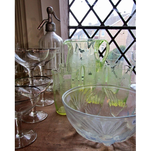 1226 - A Uranium glass lemonade jug and five glasses etched with summer flowers, five art deco style gilded... 