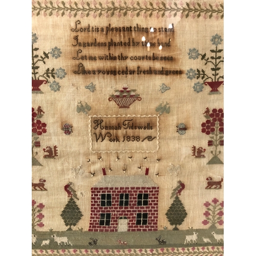 95 - 19th century needlework sampler, by Hannah Tidwells, dated 1838, with religious verse above, urns of... 