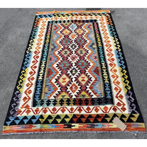 2712 - A Chobi Kilim, with a central panel of spiked multicoloured guls, 195cm x 127cm