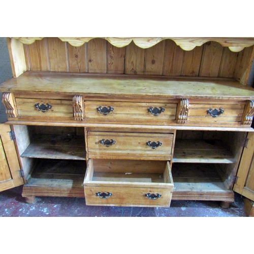 2445 - A Victorian stripped and waxed pine dresser, the base enclosed by a T shaped arrangement of five dra... 