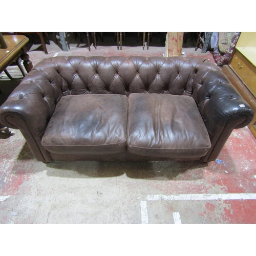 2448 - A Victorian style chesterfield in a mid brown leather, with buttoned back and scrolled arms, 190cm w... 