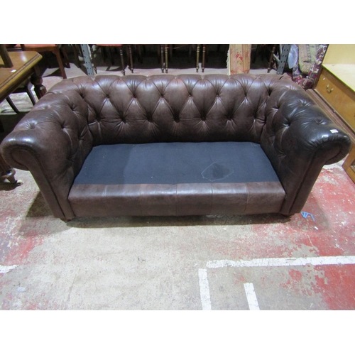 2448 - A Victorian style chesterfield in a mid brown leather, with buttoned back and scrolled arms, 190cm w... 