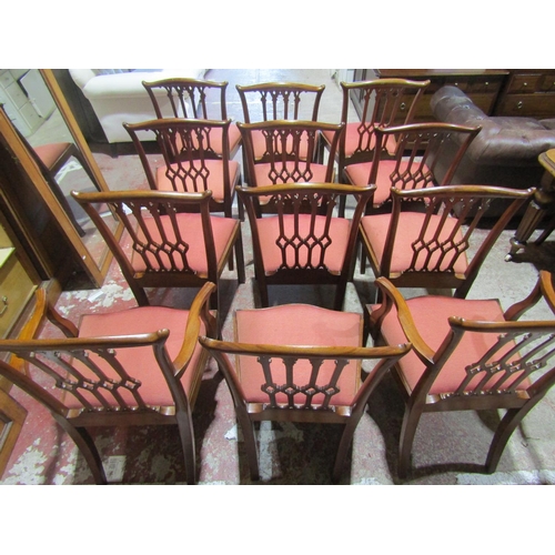 2451 - A set of twelve (10+2) George III style mahogany dining chairs with carved and pierced Gothic tracer... 