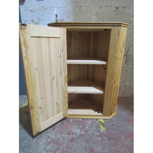 2463 - A contemporary pine corner cupboard enclosed by a door, 91cm high