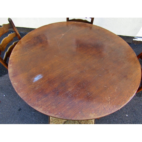 2467 - An old English style oak dining table the circular top raised on bobbin supports united by a matchin... 