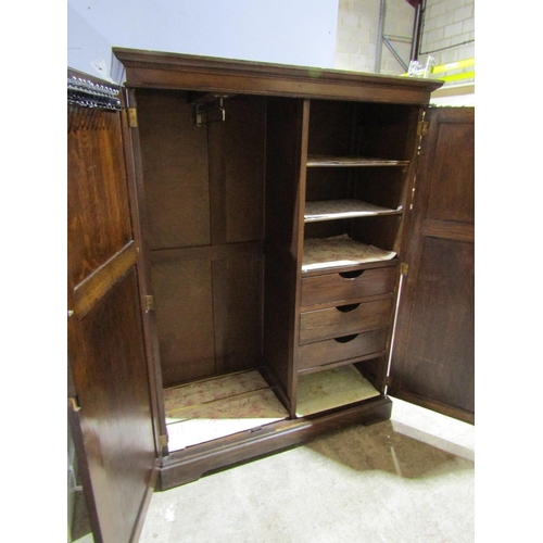 2469 - An Edwardian oak cottage wardrobe with two panelled doors, with fitted interior, 150cm high