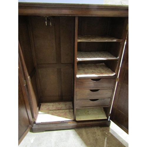 2469 - An Edwardian oak cottage wardrobe with two panelled doors, with fitted interior, 150cm high