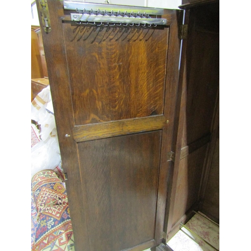 2469 - An Edwardian oak cottage wardrobe with two panelled doors, with fitted interior, 150cm high