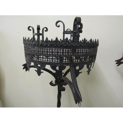 2477 - A pair of good quality had wrought iron candle stands in a Gothic manner, each supporting three cand... 