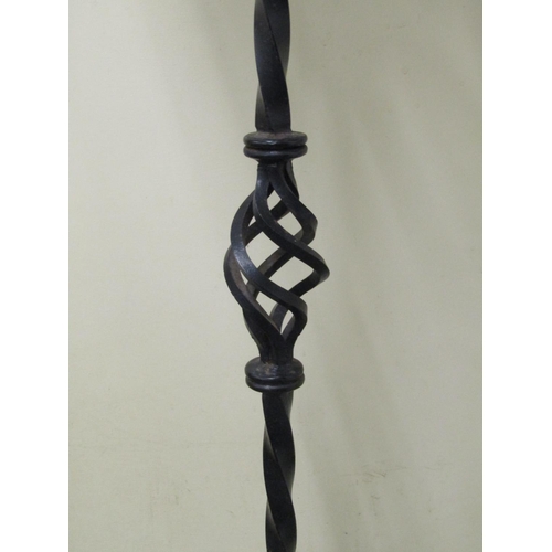 2477 - A pair of good quality had wrought iron candle stands in a Gothic manner, each supporting three cand... 