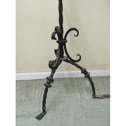 2477 - A pair of good quality had wrought iron candle stands in a Gothic manner, each supporting three cand... 